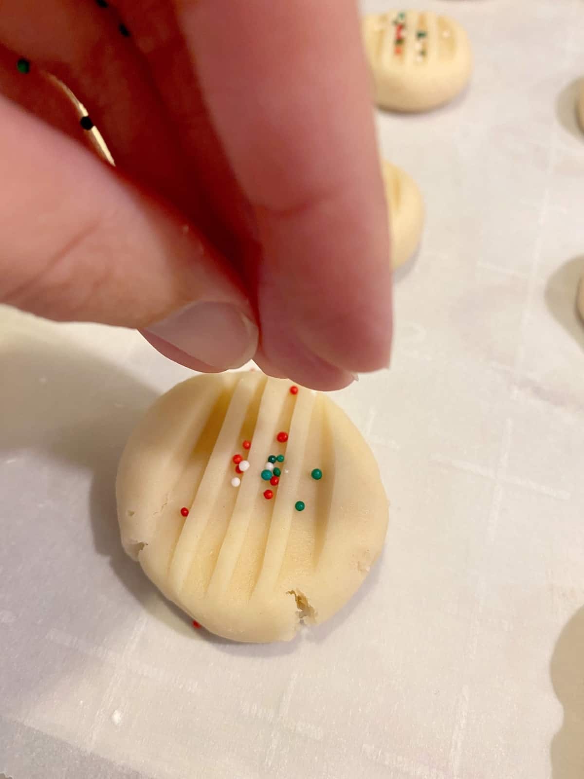 putting sprinkles on whipped shortbread cookie dough